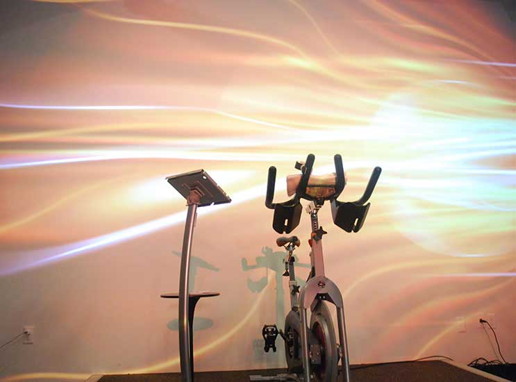 The instructor can adjust the lights, audio, and projector using an IPad from the front stage.