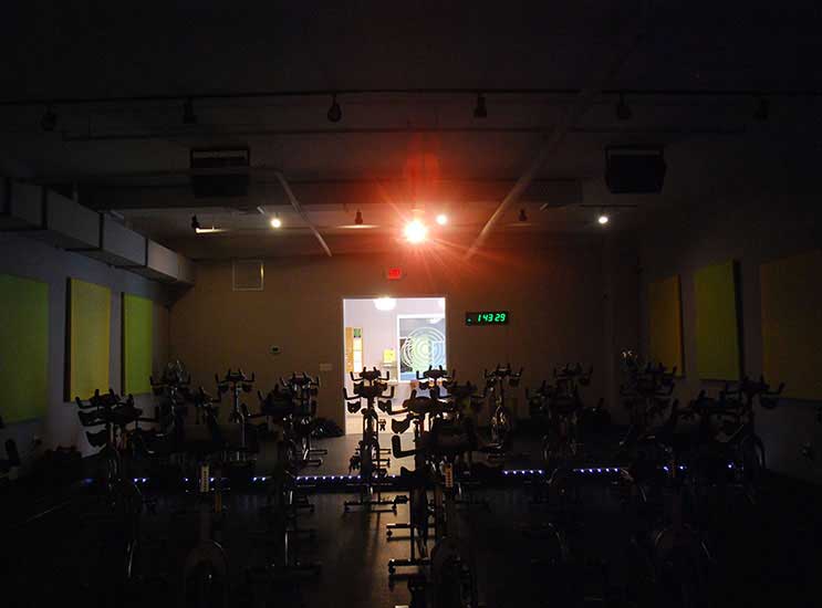 The view from the instructor bike with the lights off and the projector on.