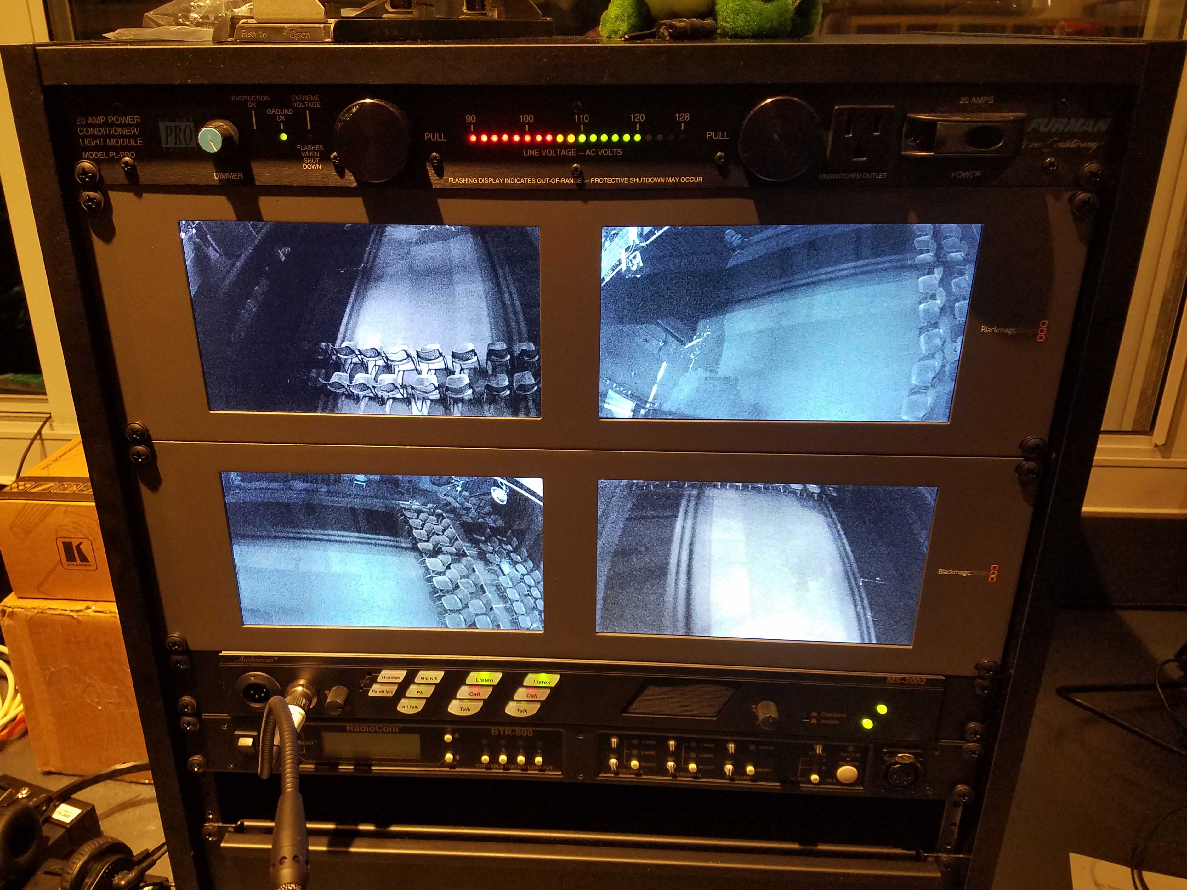 Monitors in the high school theater help stage crew